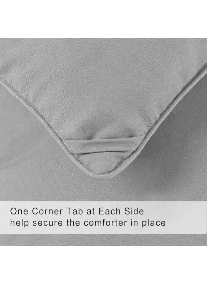 Gray comforter with corner tabs on a white background