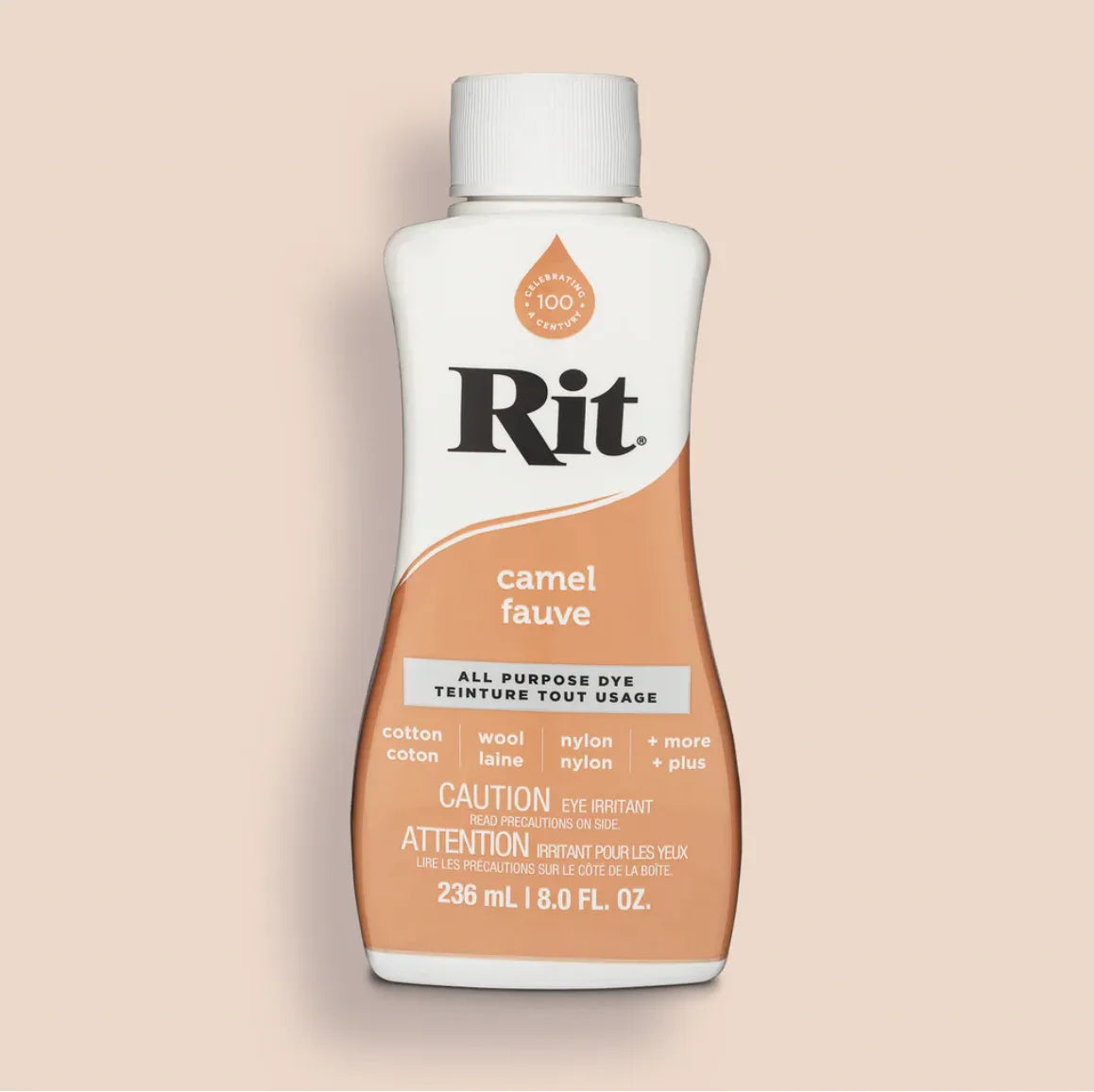Bottle of Rit all purpose dye in camel color on a beige background