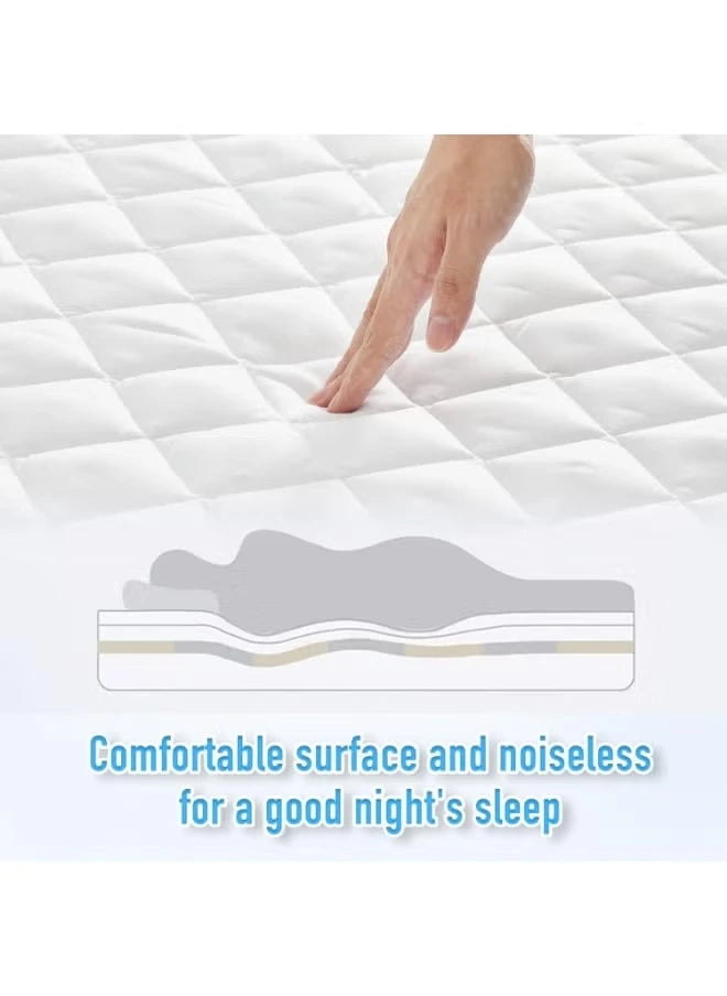 A hand touching a quilted mattress protector