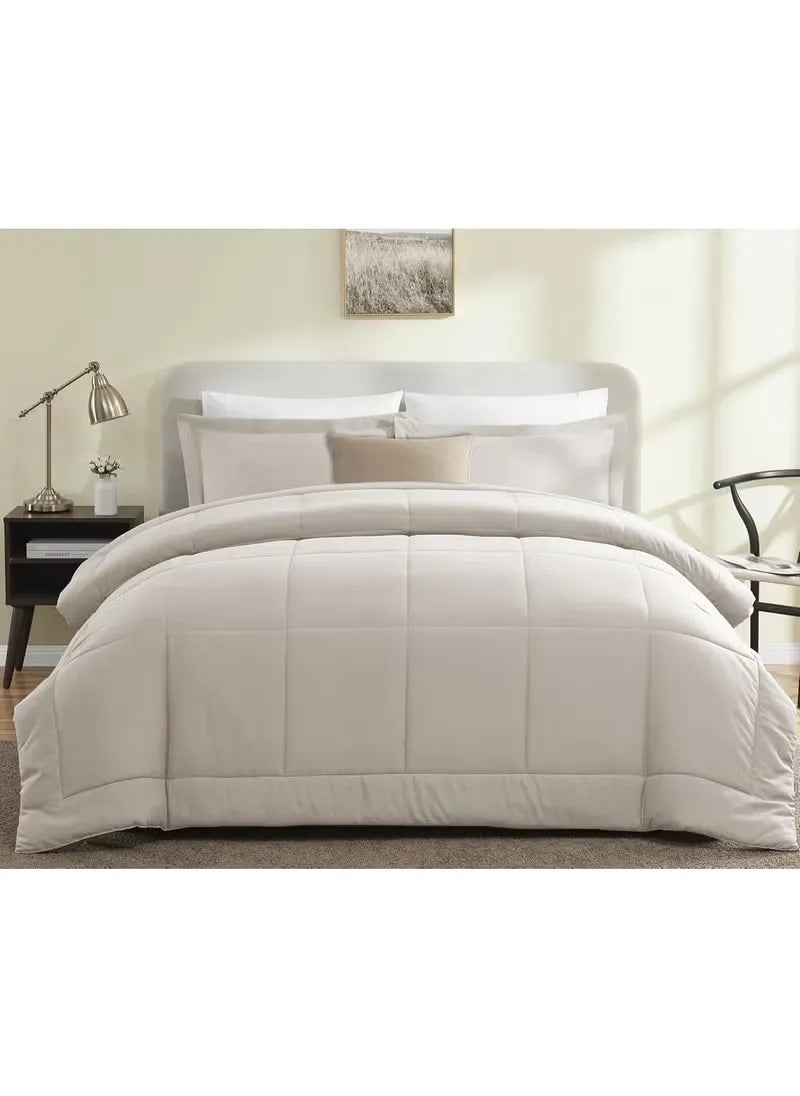 Beige comforter set on a bed in a bedroom setting