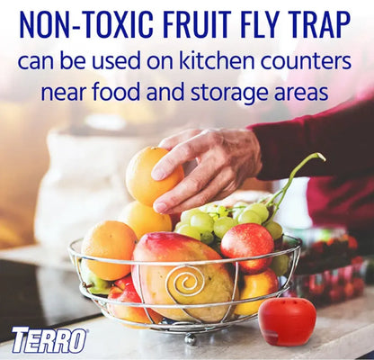 Advertisement for a Terro non-toxic fruit fly trap with a bowl of fruit and a hand reaching for an orange.