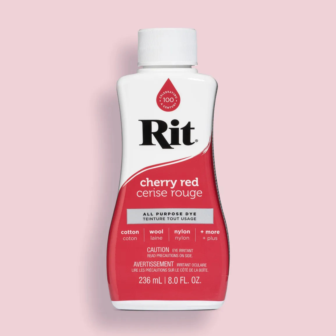 Bottle of Rit all purpose dye in cherry red color on a pink background