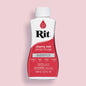 Bottle of Rit all purpose dye in cherry red color on a pink background