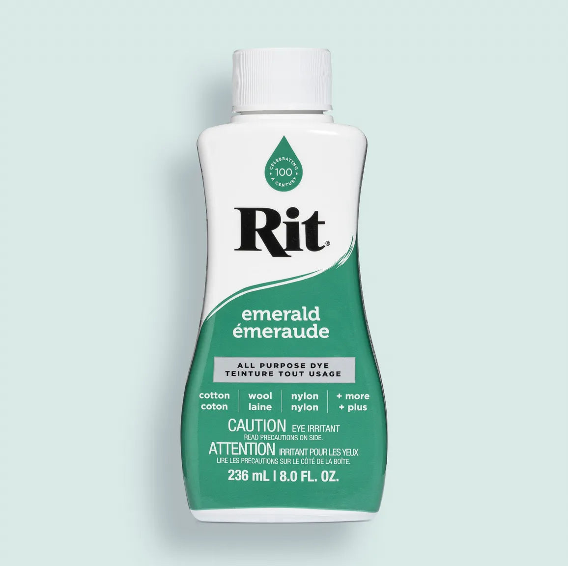 Bottle of Rit dye in emerald color on a light blue background