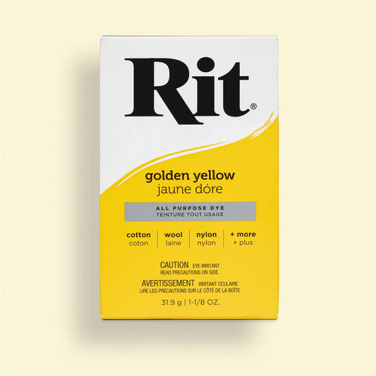 Rit dye packaging in golden yellow on a light beige background