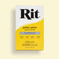Rit dye packaging in golden yellow on a light beige background