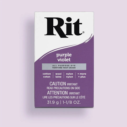 Rit dye packet for purple violet color on a light purple background